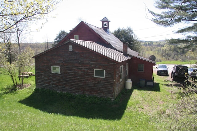 2884 Tampico Rd, Danville, VT 05828 - view of side of home featuring a standing seam roof, metal roof, and a lawn