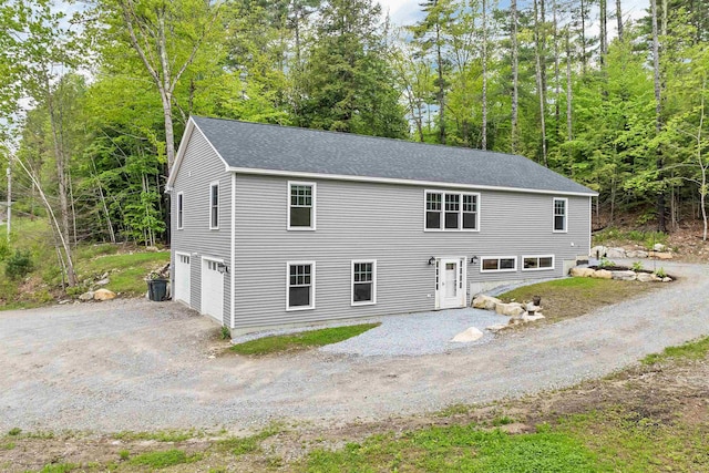 10 Call Rd, Webster, NH 03303 - view of front of house with a garage, dirt driveway, and roof with shingles