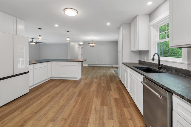 10 Call Rd, Webster, NH 03303 - kitchen with stainless steel dishwasher, freestanding refrigerator, a sink, dark countertops, and light wood-style floors