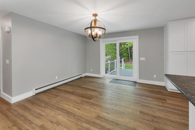 10 Call Rd, Webster, NH 03303 - unfurnished dining area with baseboard heating, baseboards, a chandelier, and wood finished floors