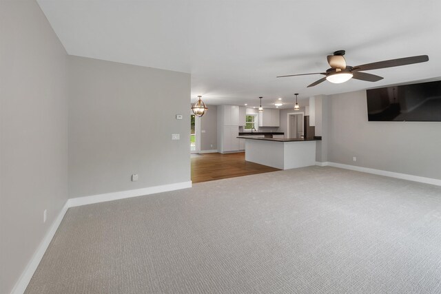 10 Call Rd, Webster, NH 03303 - unfurnished living room featuring light colored carpet, ceiling fan, and baseboards