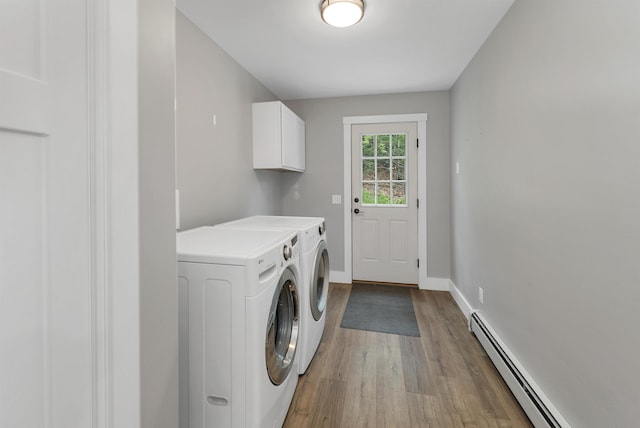 10 Call Rd, Webster, NH 03303 - laundry area with washing machine and dryer, a baseboard heating unit, cabinet space, light wood-style flooring, and baseboards