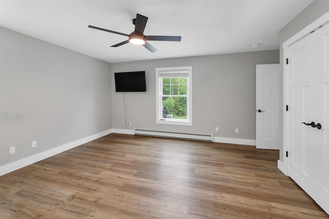 10 Call Rd, Webster, NH 03303 - empty room featuring a baseboard heating unit, baseboards, ceiling fan, and wood finished floors