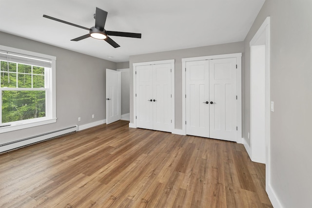 10 Call Rd, Webster, NH 03303 - unfurnished bedroom featuring baseboards, light wood-style flooring, and multiple closets