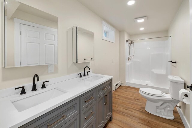 10 Call Rd, Webster, NH 03303 - full bath featuring baseboard heating, toilet, walk in shower, wood finished floors, and double vanity