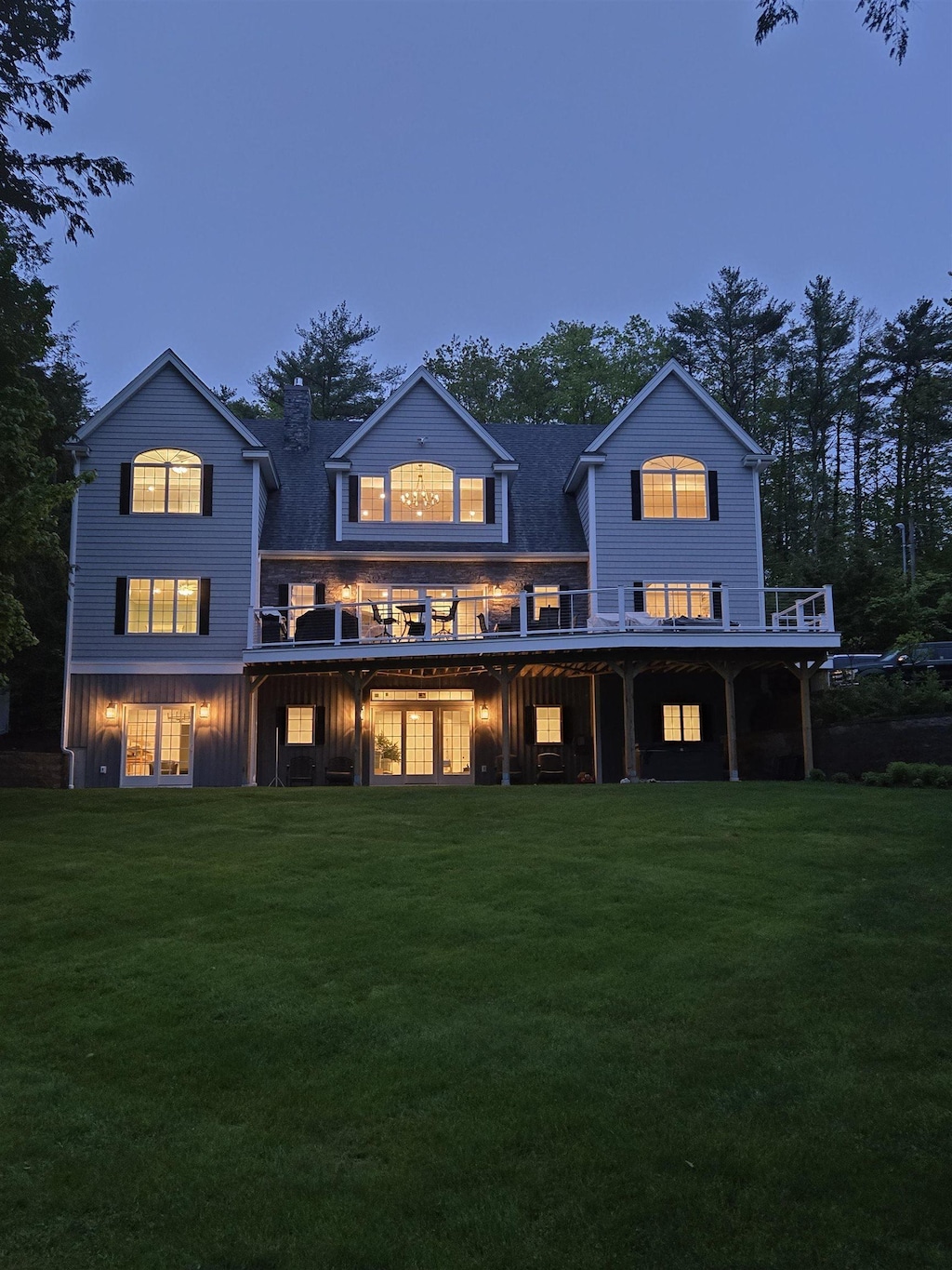 11 Quimby Rd, Meredith, NH 03253 - rear view of house featuring a yard, a chimney, board and batten siding, and a deck