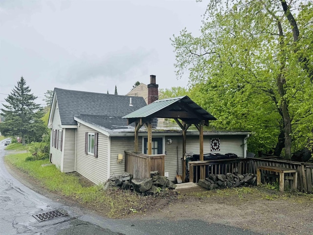 1334 Back Center Rd, Lyndon, VT 05851 - rear view of house featuring a chimney, a shingled roof, and a wooden deck