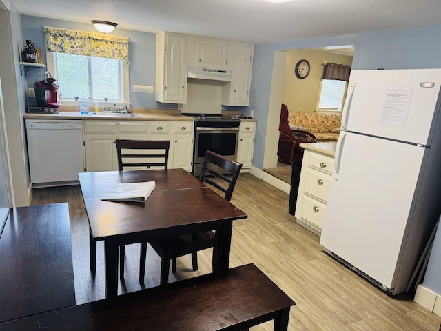 1334 Back Center Rd, Lyndon, VT 05851 - kitchen with white appliances, under cabinet range hood, white cabinetry, and light wood finished floors
