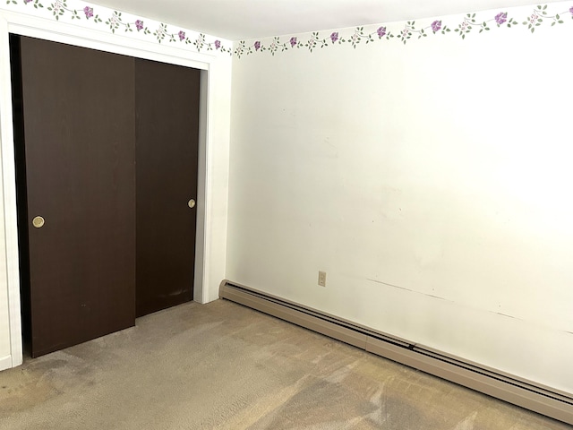 34 Hampshire Cir, Brattleboro, VT 05301 - spare room featuring a baseboard heating unit and light carpet