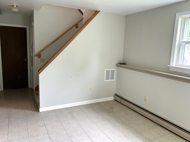 34 Hampshire Cir, Brattleboro, VT 05301 - unfurnished living room with a baseboard heating unit, stairs, light tile patterned floors, and baseboards