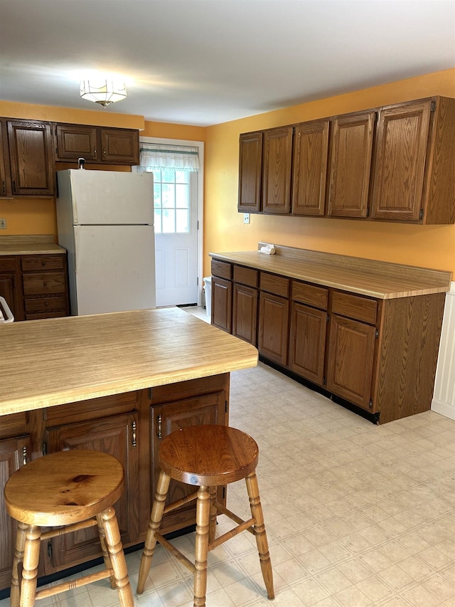 34 Hampshire Cir, Brattleboro, VT 05301 - kitchen featuring freestanding refrigerator, light countertops, and light floors