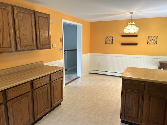 34 Hampshire Cir, Brattleboro, VT 05301 - kitchen with a wainscoted wall, a baseboard heating unit, light flooring, pendant lighting, and light countertops