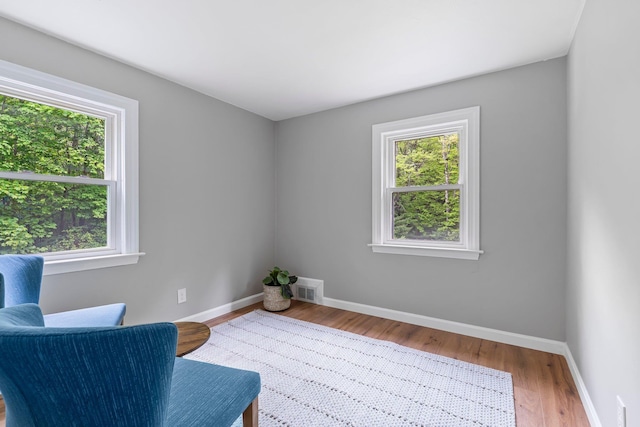 65 Sanborn St, Laconia, NH 03246 - living area with healthy amount of natural light, wood finished floors, and baseboards