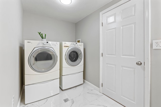 65 Sanborn St, Laconia, NH 03246 - washroom featuring washing machine and clothes dryer, light marble finish floors, and baseboards