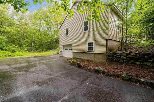 65 Sanborn St, Laconia, NH 03246 - view of side of home featuring driveway and a garage
