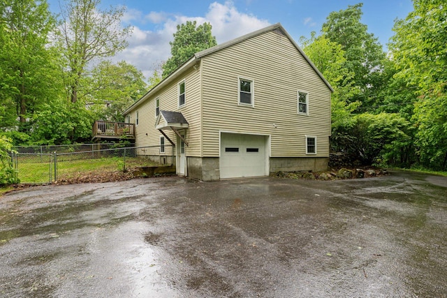 65 Sanborn St, Laconia, NH 03246 - view of property exterior featuring driveway, an attached garage, and a wooden deck