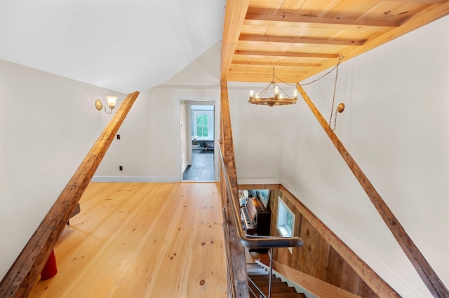 2192 Jack Hill Rd, Calais, VT 05650 - staircase with a chandelier, wood ceiling with exposed beams, wood-type flooring, and baseboards