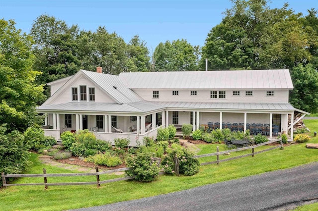 2192 Jack Hill Rd, Calais, VT 05650 - country-style home featuring a front lawn, a porch, a chimney, and metal roof