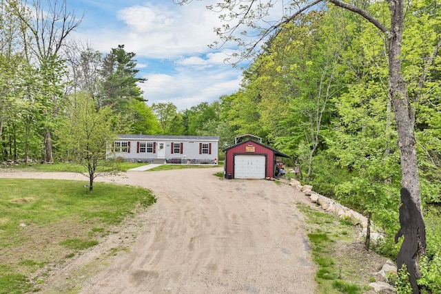 29 Stoneham Rd Unit 4, Wakefield, NH 03872 - manufactured / mobile home featuring driveway, an outdoor structure, a detached garage, and a wooded view