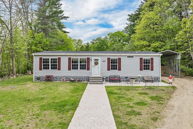 29 Stoneham Rd Unit 4, Wakefield, NH 03872 - manufactured / mobile home with a front yard and a detached carport