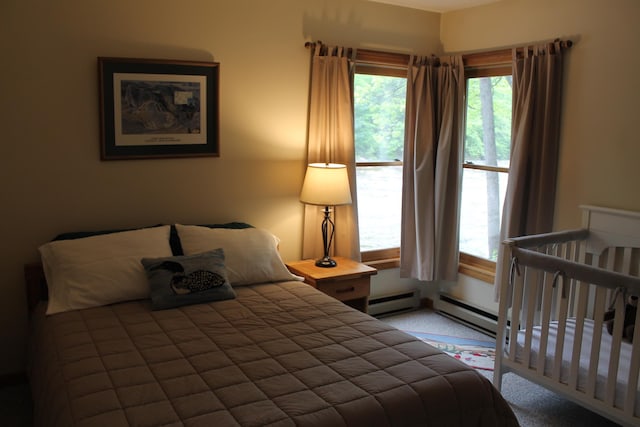 16 Penstock Rd Unit 4, Lincoln, NH 03251 - bedroom with a baseboard heating unit, multiple windows, and carpet