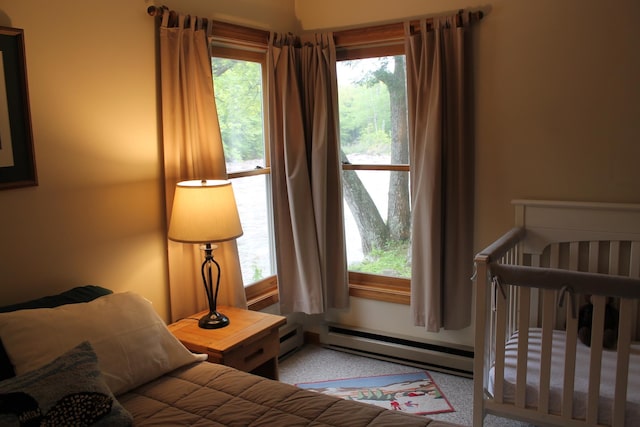 16 Penstock Rd Unit 4, Lincoln, NH 03251 - carpeted bedroom featuring a baseboard heating unit and multiple windows