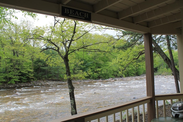 16 Penstock Rd Unit 4, Lincoln, NH 03251 - wooden deck with a view of trees and a water view
