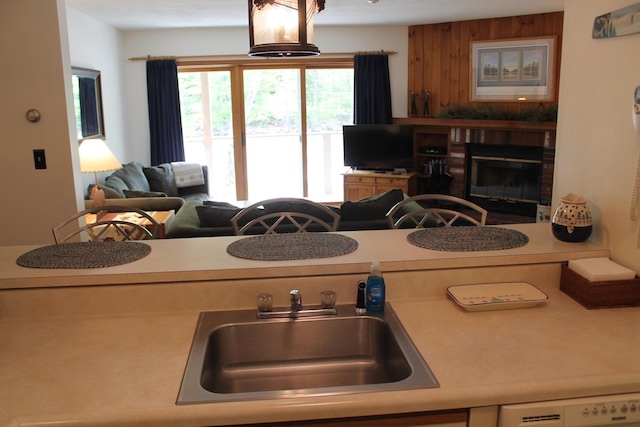 16 Penstock Rd Unit 4, Lincoln, NH 03251 - kitchen featuring a sink, light countertops, open floor plan, a fireplace, and dishwasher