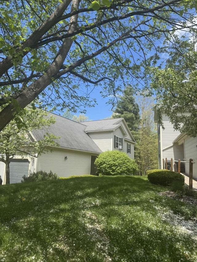 87 Juniper Dr, South Burlington, VT 05403 - view of home's exterior with an attached garage and a lawn