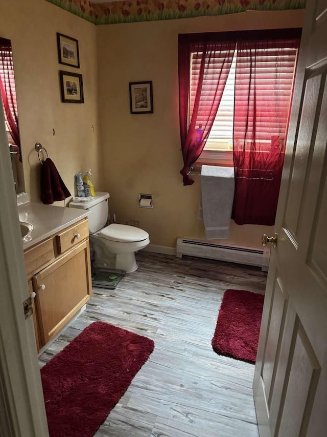 87 Juniper Dr, South Burlington, VT 05403 - bathroom with vanity, a baseboard heating unit, toilet, wood finished floors, and baseboards