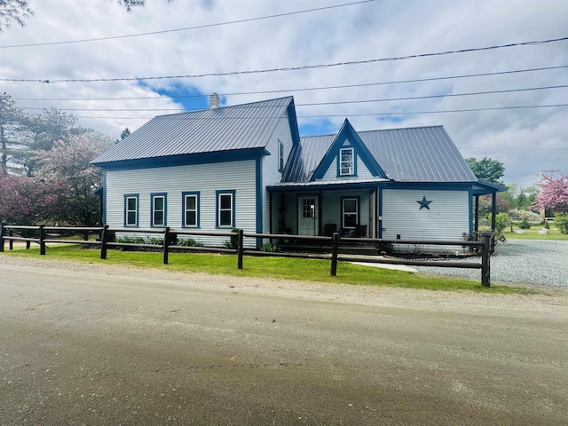 36 Sand St, Lancaster, NH 03584 - view of front of property featuring a fenced front yard, a chimney, and metal roof