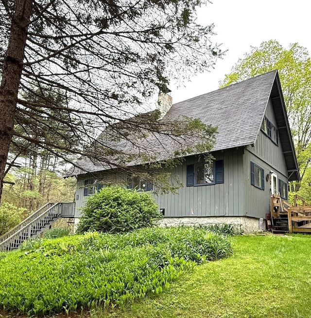 191 Highland Rd, Wallingford, VT 05773 - view of side of property featuring a shingled roof, a chimney, stairs, and a lawn