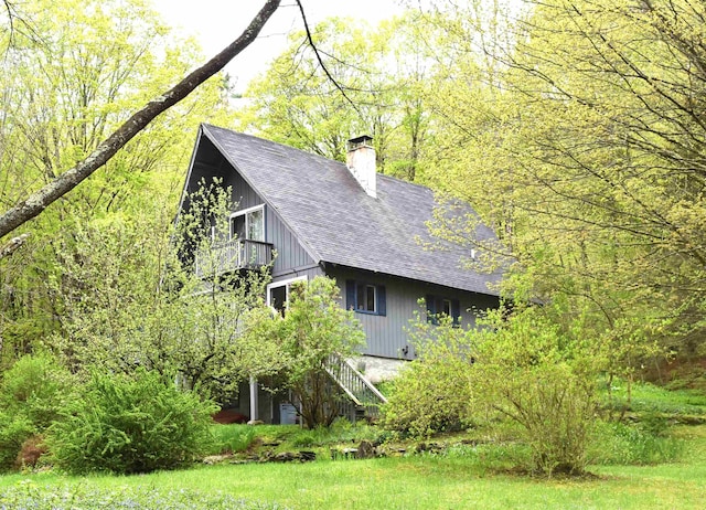 191 Highland Rd, Wallingford, VT 05773 - view of property exterior featuring roof with shingles, a chimney, stairway, and a balcony