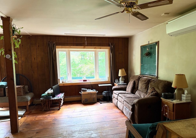191 Highland Rd, Wallingford, VT 05773 - living room featuring light wood-style flooring, a wall mounted air conditioner, ceiling fan, and wood walls
