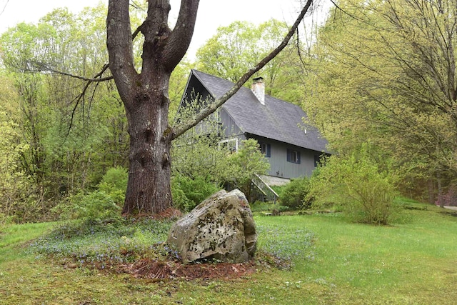 191 Highland Rd, Wallingford, VT 05773 - view of side of home with a chimney, roof with shingles, and a yard