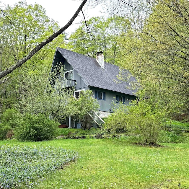 191 Highland Rd, Wallingford, VT 05773 - view of side of property with a chimney, stairs, a shingled roof, and a yard