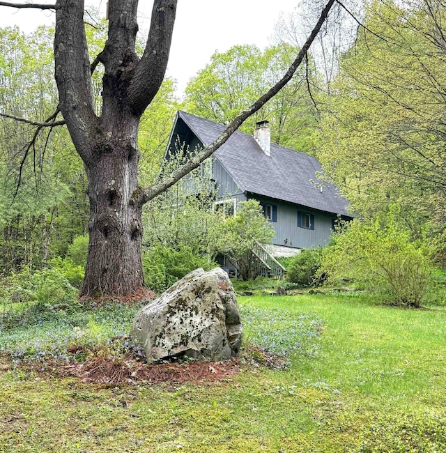 191 Highland Rd, Wallingford, VT 05773 - view of property exterior featuring a chimney, a shingled roof, and stairs