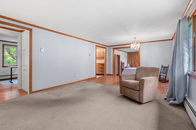 28 Joslin Rd, Swanzey, NH 03431 - living area with a baseboard heating unit, a chandelier, ornamental molding, light colored carpet, and baseboards