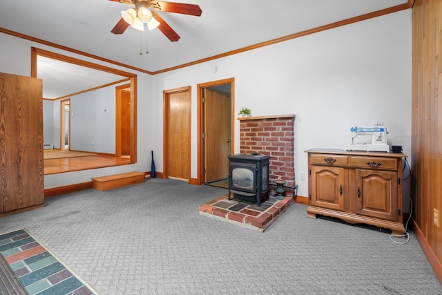 28 Joslin Rd, Swanzey, NH 03431 - unfurnished living room featuring ornamental molding, a wood stove, carpet flooring, a ceiling fan, and a baseboard heating unit