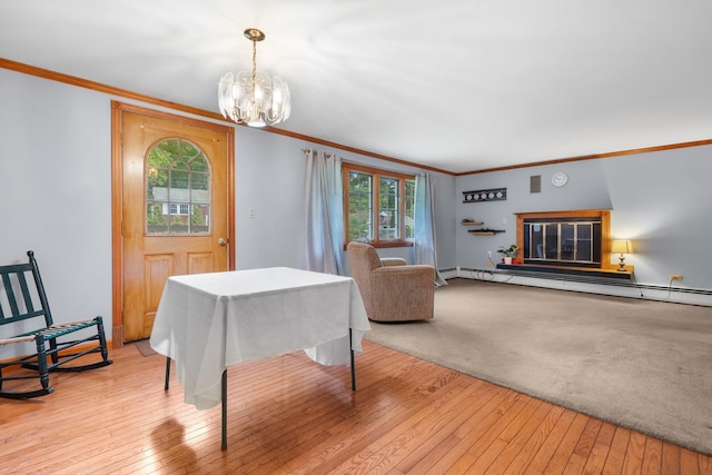 28 Joslin Rd, Swanzey, NH 03431 - dining space featuring baseboard heating, a chandelier, crown molding, wood-type flooring, and healthy amount of natural light