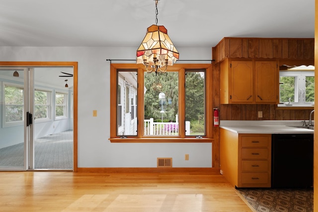 33 Wildwood Dr, Burlington, VT 05408 - kitchen with wood finished floors, dishwasher, light countertops, and decorative light fixtures