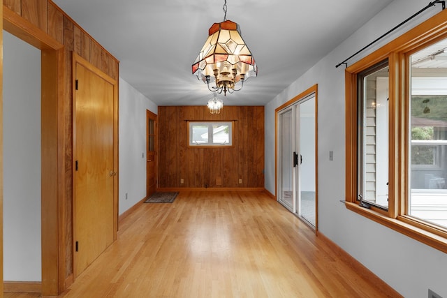 33 Wildwood Dr, Burlington, VT 05408 - unfurnished dining area featuring light wood finished floors, a chandelier, and baseboards