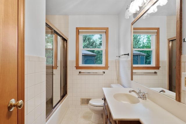 33 Wildwood Dr, Burlington, VT 05408 - full bath with tile walls, plenty of natural light, wainscoting, toilet, and vanity