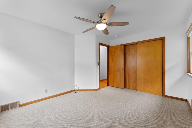 33 Wildwood Dr, Burlington, VT 05408 - unfurnished bedroom featuring light carpet, a closet, baseboards, and a ceiling fan