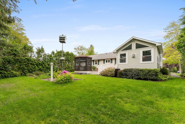 33 Wildwood Dr, Burlington, VT 05408 - rear view of property featuring a deck, a lawn, and a sunroom