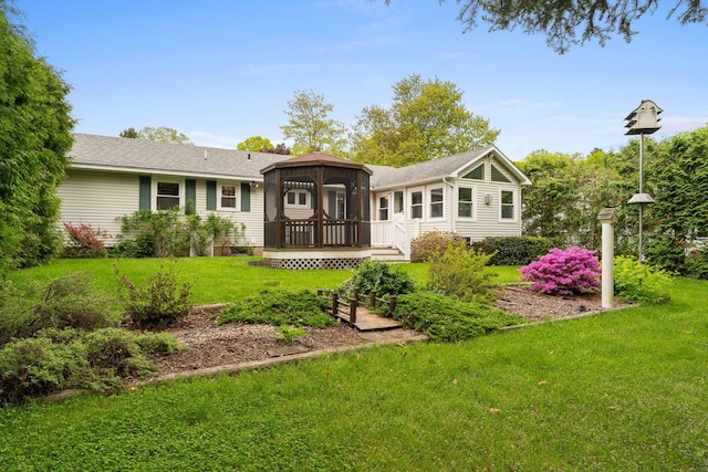 33 Wildwood Dr, Burlington, VT 05408 - rear view of property featuring a wooden deck, a yard, a sunroom, and a shingled roof