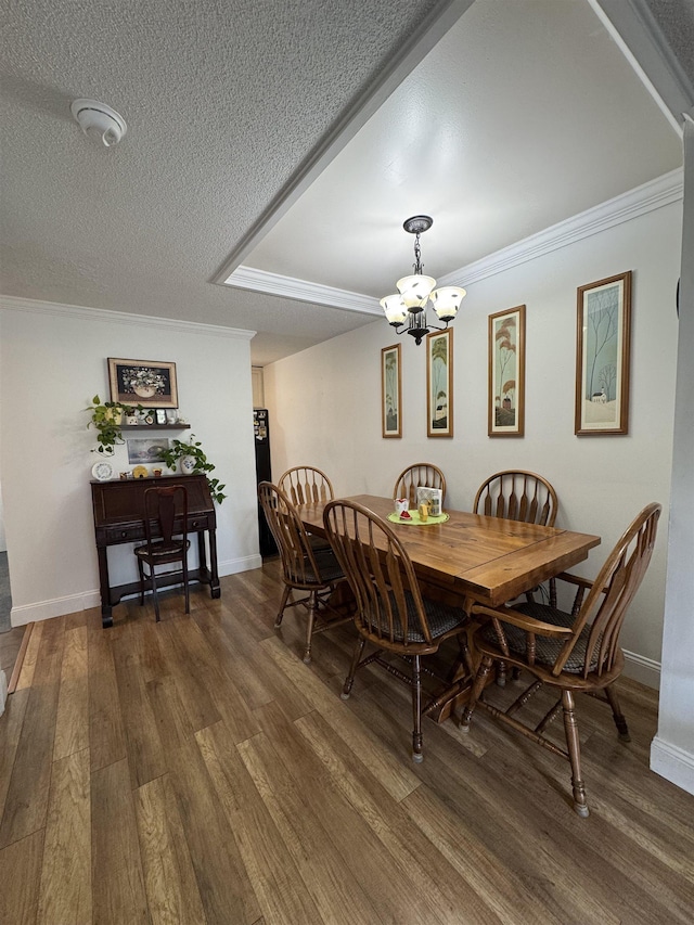 11 Modena Dr Unit 11, Concord, NH 03303 - dining area featuring a chandelier, wood finished floors, ornamental molding, a textured ceiling, and baseboards