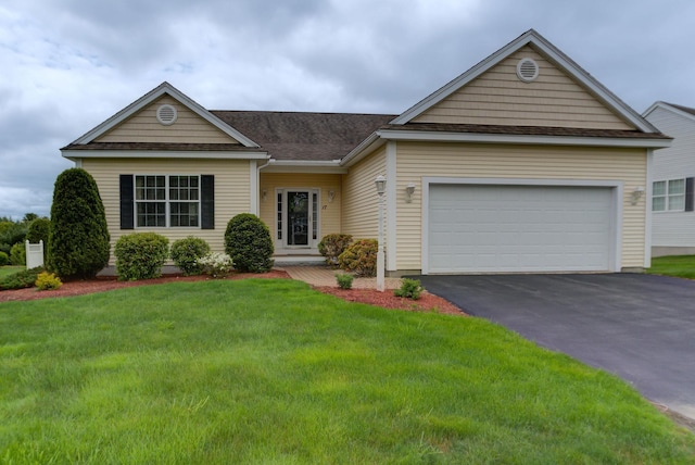17 Misty Meadow Rd Unit 17, Windham, NH 03087 - view of front of property featuring driveway, a front lawn, an attached garage, and a shingled roof
