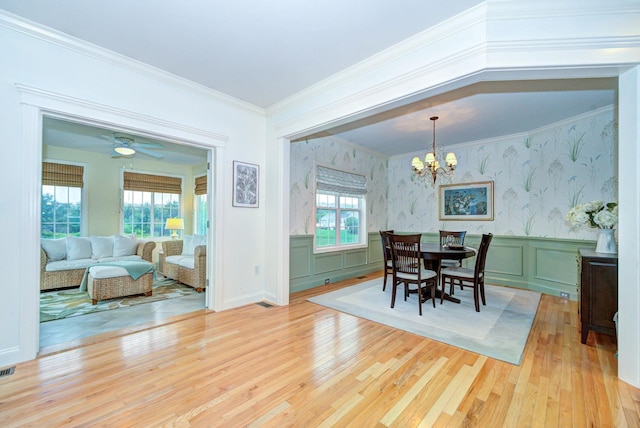 17 Misty Meadow Rd Unit 17, Windham, NH 03087 - dining room with light wood-style flooring, a wainscoted wall, ornamental molding, a chandelier, and wallpapered walls