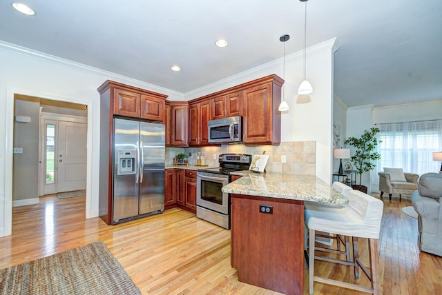17 Misty Meadow Rd Unit 17, Windham, NH 03087 - kitchen with stainless steel appliances, a peninsula, light wood finished floors, tasteful backsplash, and light stone countertops